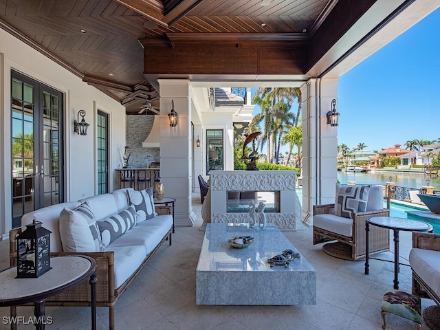 233 Mermaids Bight, Naples, FL 34103 - view of patio with an outdoor hangout area, french doors, and a water view