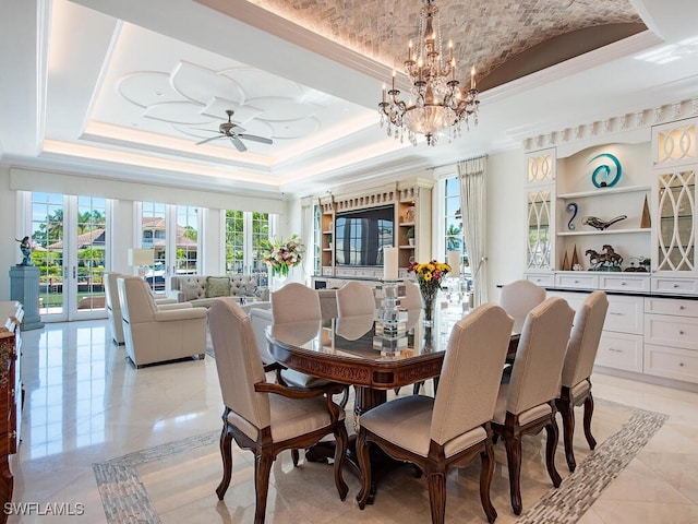 233 Mermaids Bight, Naples, FL 34103 - dining room with light tile patterned floors, ceiling fan with notable chandelier, crown molding, and a tray ceiling