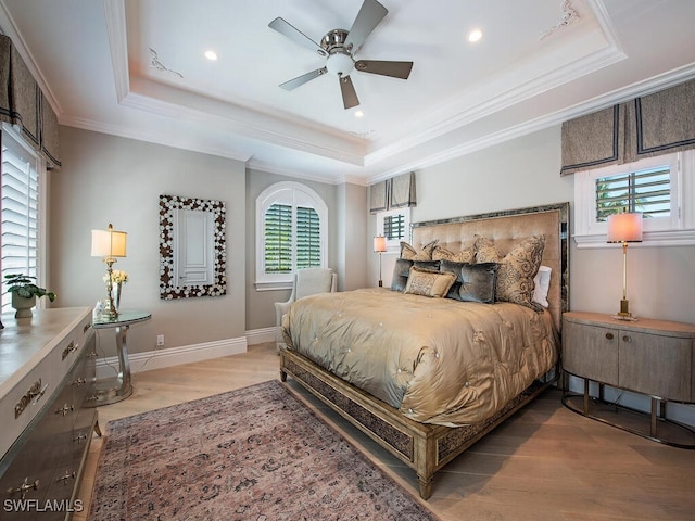 233 Mermaids Bight, Naples, FL 34103 - bedroom featuring a raised ceiling, light wood-style floors, recessed lighting, and multiple windows