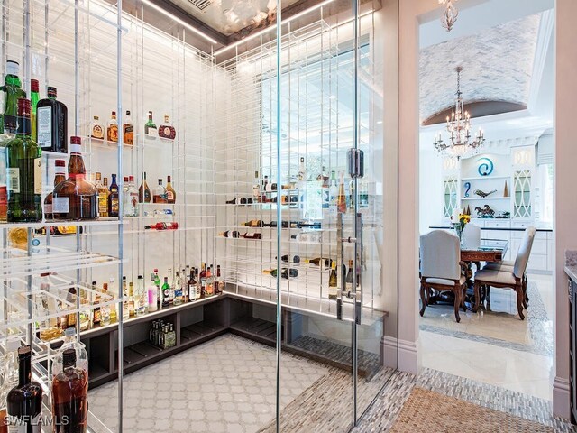 233 Mermaids Bight, Naples, FL 34103 - wine cellar featuring a chandelier and tile patterned flooring