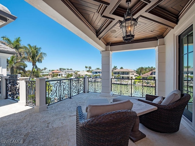 233 Mermaids Bight, Naples, FL 34103 - view of patio with a water view, a balcony, and a residential view