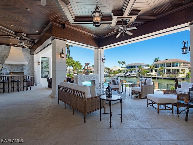233 Mermaids Bight, Naples, FL 34103 - view of patio featuring an outdoor hangout area, an outdoor bar, ceiling fan, and a water view