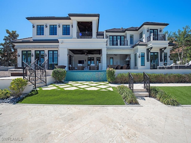 233 Mermaids Bight, Naples, FL 34103 - exterior space with french doors, ceiling fan, a balcony, and a yard