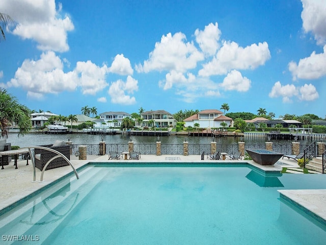 233 Mermaids Bight, Naples, FL 34103 - view of pool featuring a fenced in pool, a patio, a water view, and outdoor dry bar
