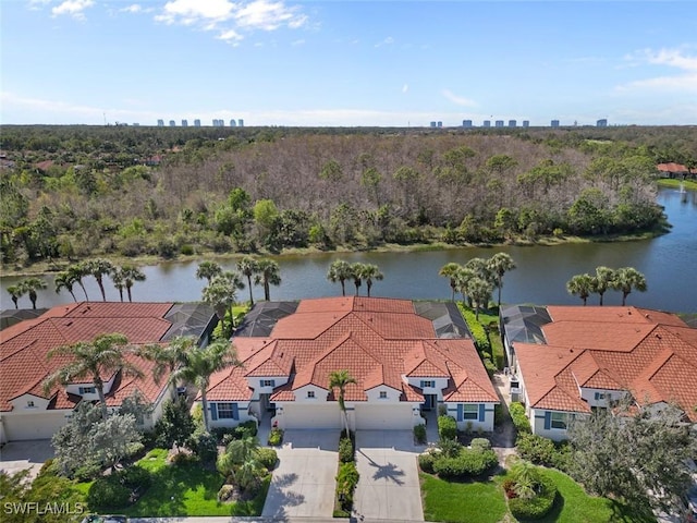 birds eye view of property featuring a water view and a forest view