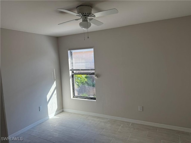 unfurnished room with baseboards and a ceiling fan
