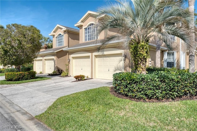 23039 Lone Oak Dr, Estero, FL 33928 - view of front facade with a garage, a front yard, concrete driveway, and stucco siding