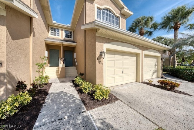 23039 Lone Oak Dr, Estero, FL 33928 - exterior space with a garage, concrete driveway, and stucco siding