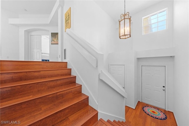 23039 Lone Oak Dr, Estero, FL 33928 - stairs with a notable chandelier and wood finished floors