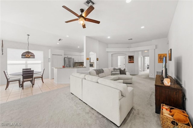 23039 Lone Oak Dr, Estero, FL 33928 - living area with light carpet, light tile patterned floors, visible vents, arched walkways, and recessed lighting