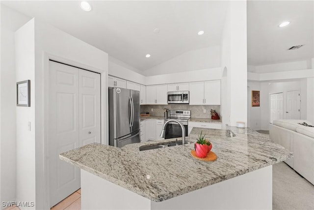23039 Lone Oak Dr, Estero, FL 33928 - kitchen featuring visible vents, white cabinets, appliances with stainless steel finishes, light stone counters, and backsplash