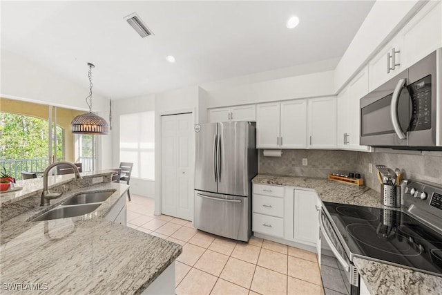 23039 Lone Oak Dr, Estero, FL 33928 - kitchen with pendant lighting, appliances with stainless steel finishes, white cabinetry, a sink, and light stone countertops