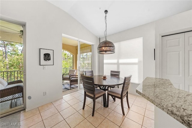23039 Lone Oak Dr, Estero, FL 33928 - dining area featuring light tile patterned floors and vaulted ceiling