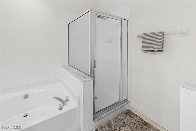 23039 Lone Oak Dr, Estero, FL 33928 - bathroom featuring a stall shower, a garden tub, and tile patterned floors