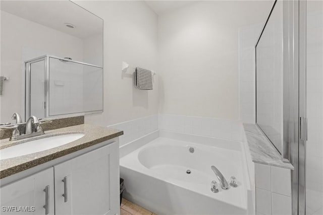 23039 Lone Oak Dr, Estero, FL 33928 - full bathroom featuring a stall shower, tile patterned floors, a garden tub, and vanity