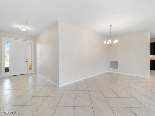 2911 SW 25th Pl, Cape Coral, FL 33914 - entrance foyer featuring a chandelier, baseboards, and light tile patterned floors