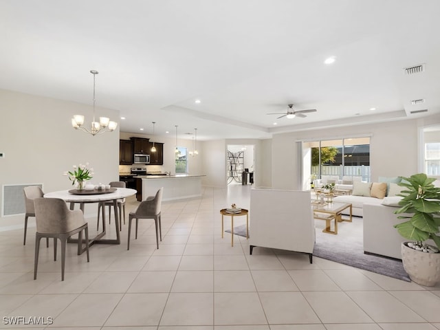 2911 SW 25th Pl, Cape Coral, FL 33914 - living area with a raised ceiling, a chandelier, ceiling fan, light tile patterned floors, and recessed lighting