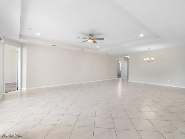 2911 SW 25th Pl, Cape Coral, FL 33914 - unfurnished room featuring a tray ceiling, recessed lighting, a ceiling fan, a chandelier, and baseboards