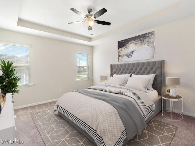 2911 SW 25th Pl, Cape Coral, FL 33914 - bedroom with carpet floors, a raised ceiling, baseboards, and ceiling fan