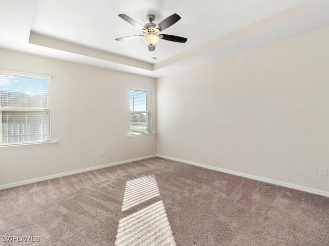 2911 SW 25th Pl, Cape Coral, FL 33914 - carpeted empty room with a raised ceiling, baseboards, and ceiling fan