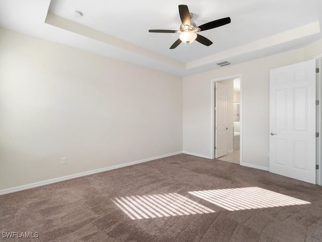 2911 SW 25th Pl, Cape Coral, FL 33914 - unfurnished bedroom with carpet floors, baseboards, a raised ceiling, and ensuite bath