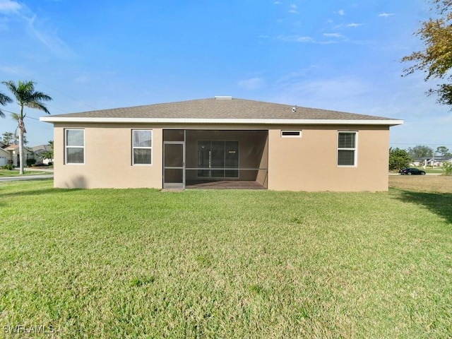 2911 SW 25th Pl, Cape Coral, FL 33914 - rear view of property featuring stucco siding, a yard, and a sunroom