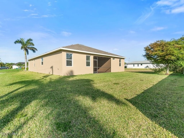 2911 SW 25th Pl, Cape Coral, FL 33914 - rear view of property featuring stucco siding and a yard