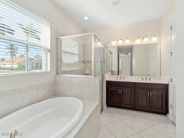 2911 SW 25th Pl, Cape Coral, FL 33914 - full bathroom featuring a garden tub, a shower stall, tile patterned flooring, and double vanity