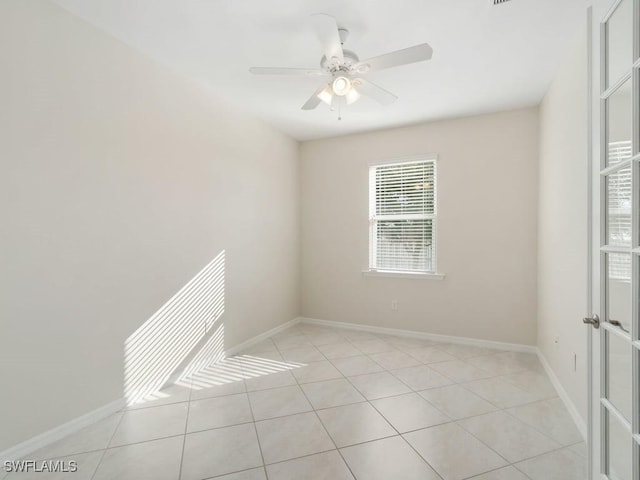 2911 SW 25th Pl, Cape Coral, FL 33914 - unfurnished room featuring light tile patterned floors, ceiling fan, and baseboards