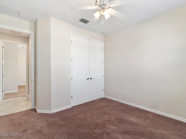 2911 SW 25th Pl, Cape Coral, FL 33914 - unfurnished bedroom featuring light carpet, a closet, baseboards, attic access, and light tile patterned flooring