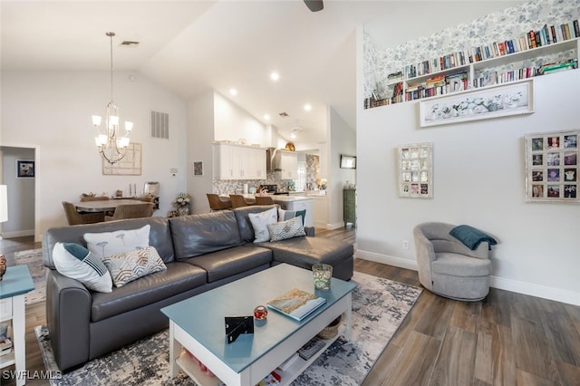 5858 Westbourgh Ct, Naples, FL 34112 - living room featuring high vaulted ceiling, wood finished floors, visible vents, and a notable chandelier