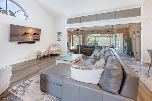 5858 Westbourgh Ct, Naples, FL 34112 - living room with a ceiling fan, lofted ceiling, baseboards, and wood finished floors