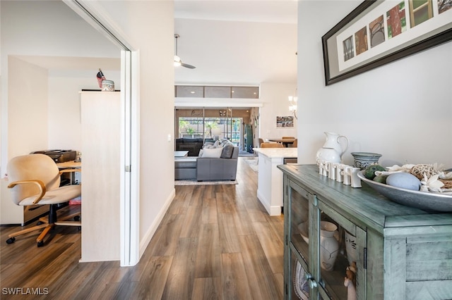 5858 Westbourgh Ct, Naples, FL 34112 - hall with baseboards, an inviting chandelier, and wood finished floors