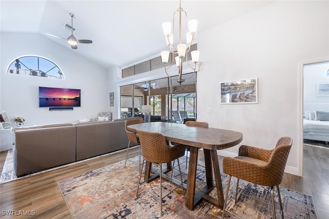 5858 Westbourgh Ct, Naples, FL 34112 - dining area with high vaulted ceiling, ceiling fan with notable chandelier, baseboards, and wood finished floors