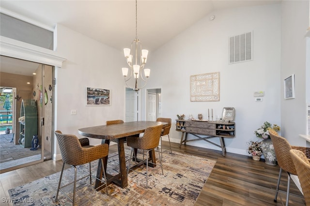 5858 Westbourgh Ct, Naples, FL 34112 - dining room featuring dark wood-type flooring, visible vents, a notable chandelier, and high vaulted ceiling