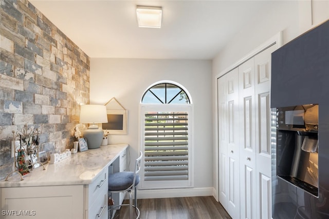 5858 Westbourgh Ct, Naples, FL 34112 - home office featuring an accent wall and dark wood-type flooring