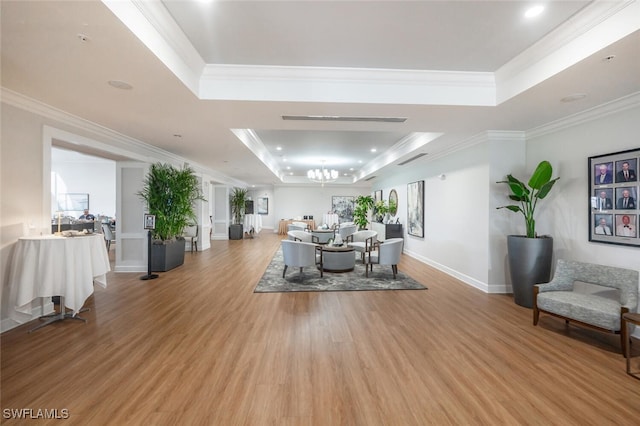 5858 Westbourgh Ct, Naples, FL 34112 - dining area with crown molding, a raised ceiling, light wood-style flooring, and a notable chandelier