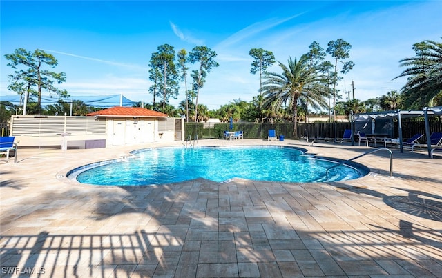 5858 Westbourgh Ct, Naples, FL 34112 - community pool featuring a patio and fence