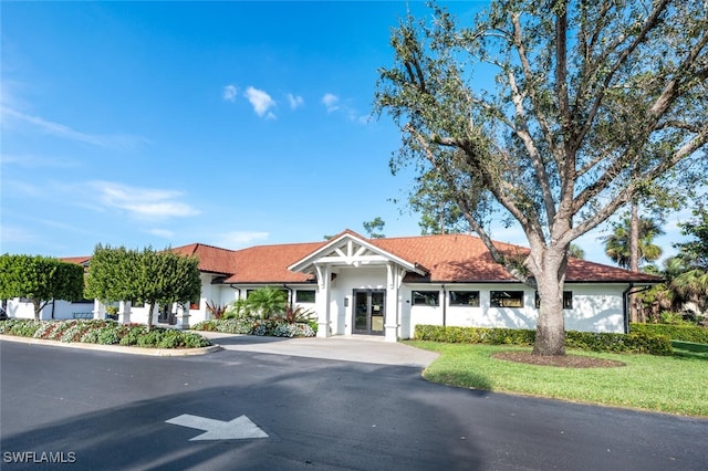5858 Westbourgh Ct, Naples, FL 34112 - view of front facade featuring aphalt driveway and stucco siding