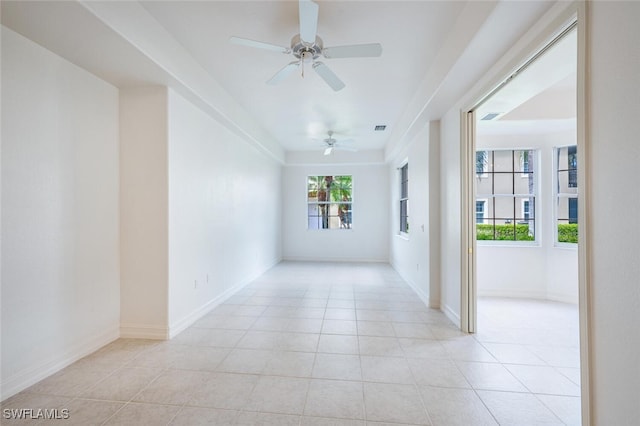 unfurnished room featuring light tile patterned floors, visible vents, and baseboards