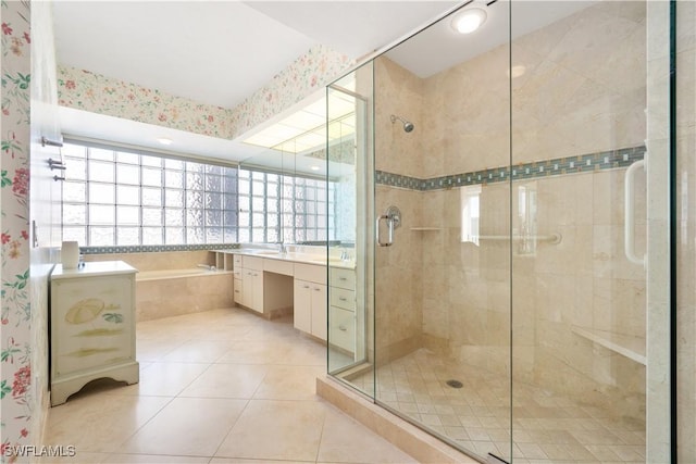 bathroom featuring a stall shower, tile patterned floors, vanity, and a bath