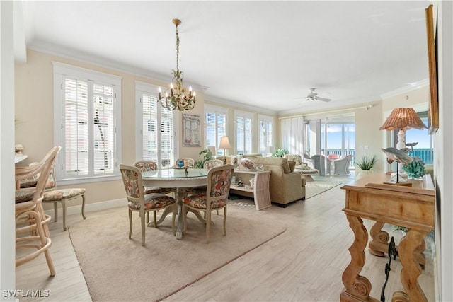 dining room with ornamental molding, plenty of natural light, and light wood finished floors