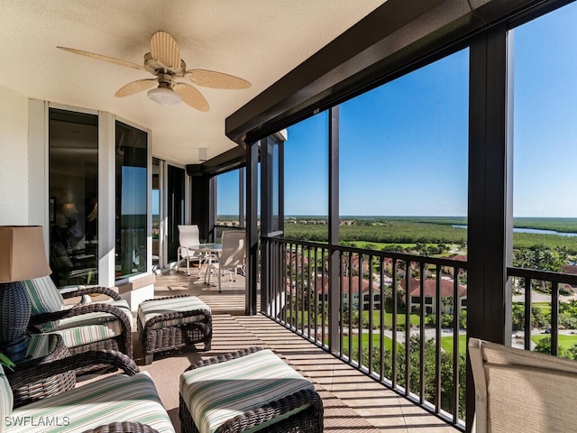 sunroom with ceiling fan and a wealth of natural light