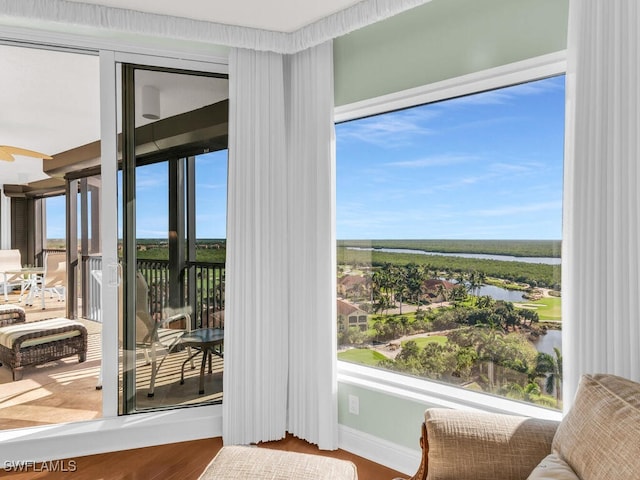 doorway to outside with hardwood / wood-style flooring and a water view