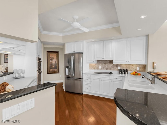 kitchen with sink, ornamental molding, white cabinets, and appliances with stainless steel finishes