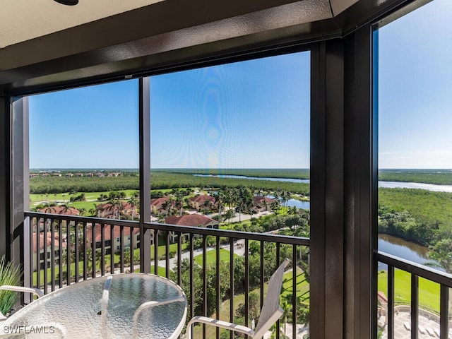 sunroom with a water view