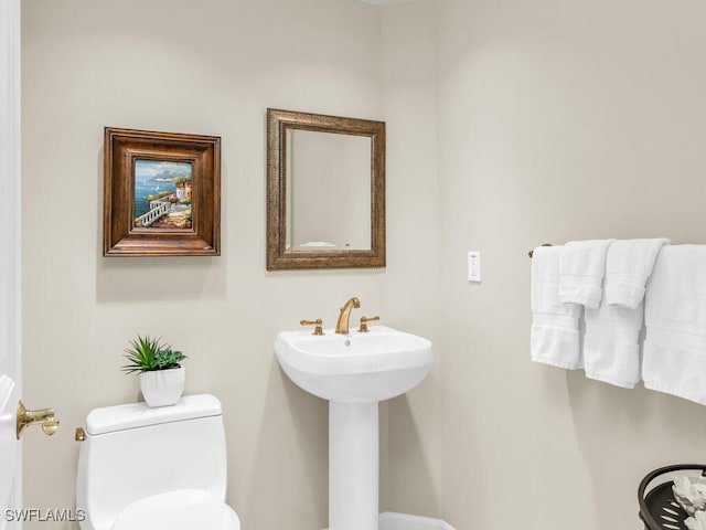 bathroom with toilet and sink