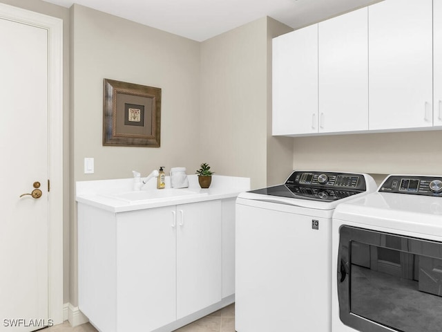 washroom featuring sink, cabinets, and independent washer and dryer