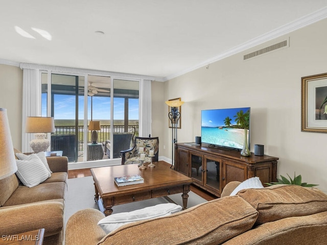 living room featuring crown molding, floor to ceiling windows, and hardwood / wood-style floors