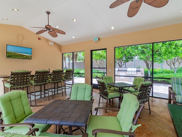 sunroom / solarium with lofted ceiling and ceiling fan